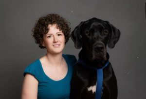 Service dog trainer Anneliese Staff with black labrador retriever
