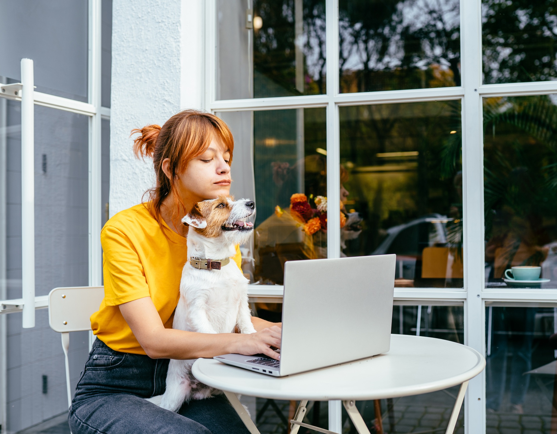 Student studying online with her dog in her lap